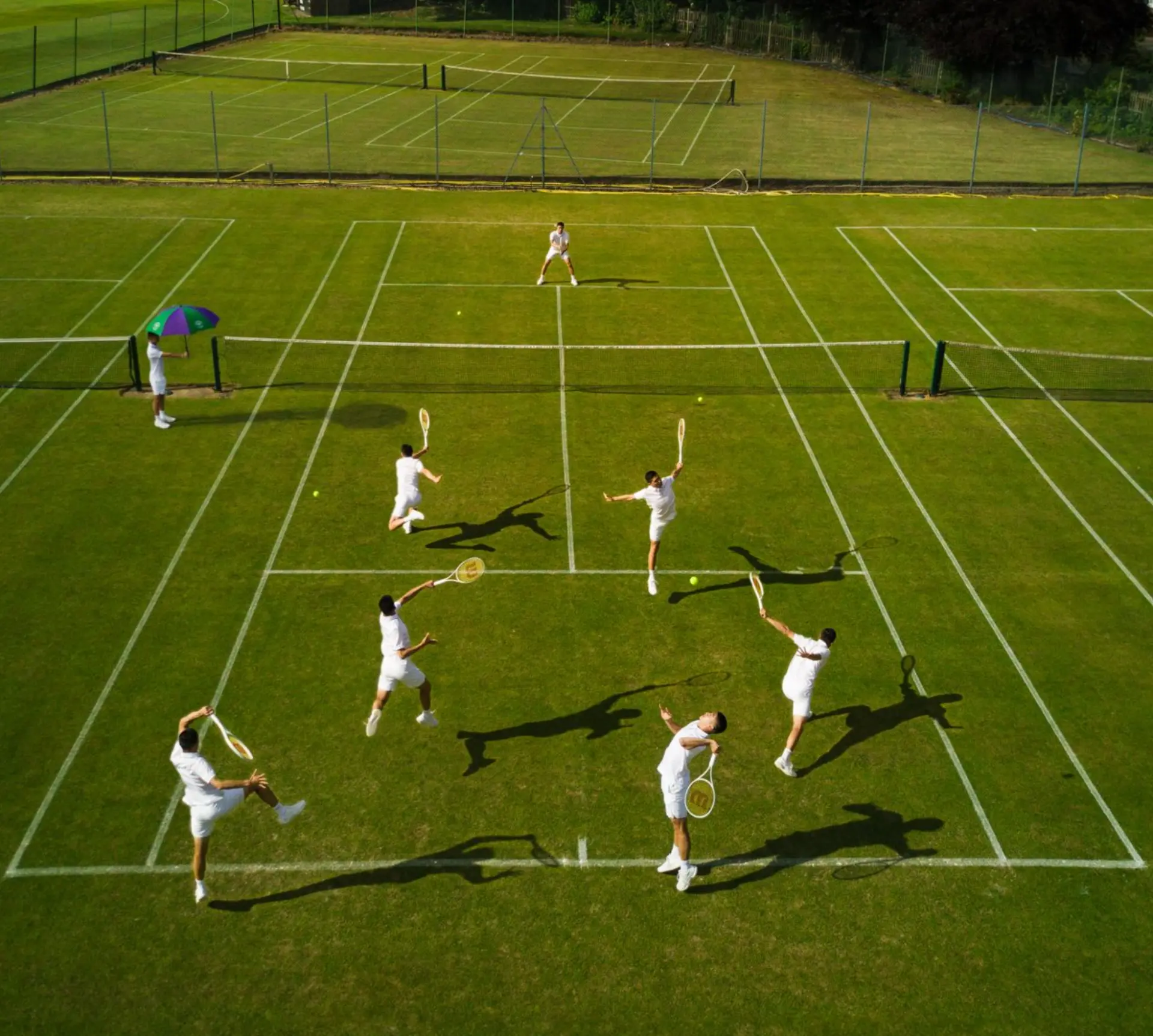 Aerial view of a doubles match on grass courts